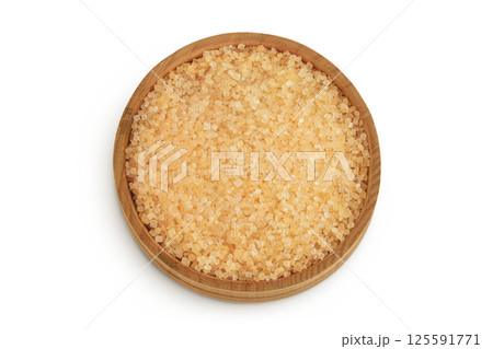 The brown sugar in wooden bowl isolated on white background. Top view. Flat lay The brown sugar in wooden bowl isolated on white background. Top view. Flat lay 125591771