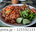 Traditional West African Benachin Rice with Fresh Vegetables on a White Plate 125592133