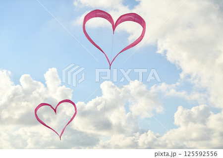 Pink heart kite is flying in the wind 125592556