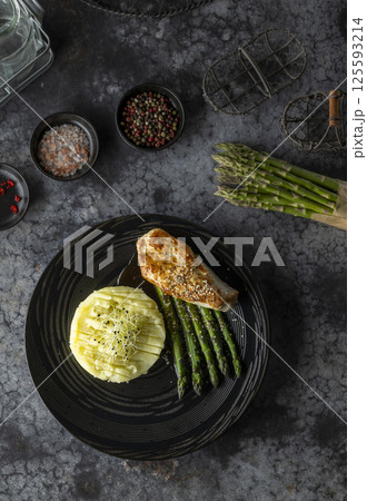 Sesame crusted chicken breast served with mashed potatoes and asparagus 125593214