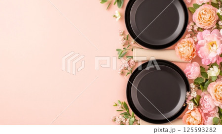 Close-up of glossy Japchae noodles with sauteed vegetables being lifted by chopsticks against a neutral background 125593282