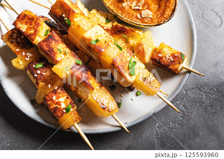 Grilled tofu satay skewers and peanut spicy sauce 125593960