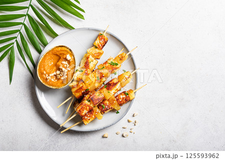Grilled tofu satay skewers and peanut spicy sauce Grilled tofu satay skewers and peanut spicy sauce 125593962