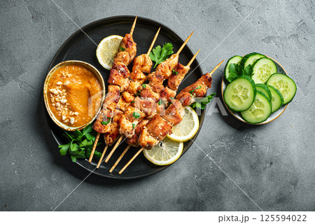 Grilled chicken satay with spicy peanut sauce 125594022