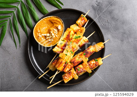 Grilled tofu satay skewers and peanut spicy sauce 125594029