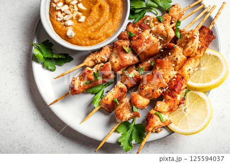 Chicken satay skewers with spicy peanut sauce 125594037