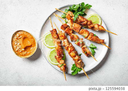 Malaysian chicken satay skewers with peanut sauce Malaysian chicken satay skewers with peanut sauce 125594038