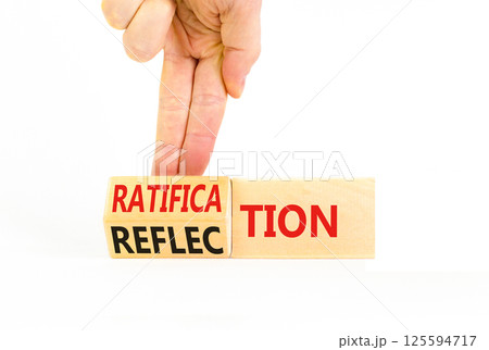 Ratification or reflection symbol. Concept words Ratification Reflection on wooden cubes. Beautiful white background. Businessman hand. Business and ratification or reflection concept. Copy space. Ratification or reflection symbol. Concept words Ratification Reflection on wooden cubes. Beautiful white background. Businessman hand. Business and ratification or reflection concept. Copy space. 125594717