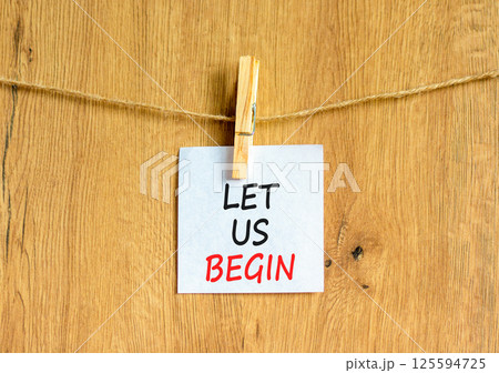 Let us begin symbol. Concept words Let us begin on beautiful white paper on clothespin. Beautiful wooden background. Business motivational let us begin concept. Copy space. Let us begin symbol. Concept words Let us begin on beautiful white paper on clothespin. Beautiful wooden background. Business motivational let us begin concept. Copy space. 125594725