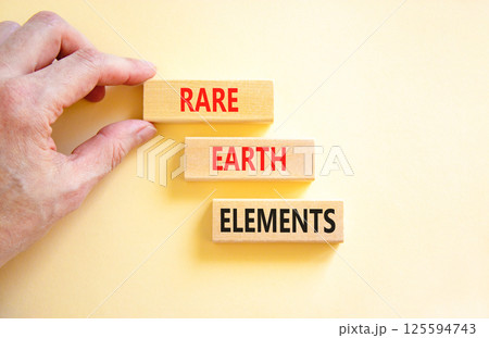 Rare earth elements symbol. Concept words Rare earth elements on beautiful wooden block. Businessman's hand. Beautiful white background. Business and rare earth elements concept. Copy space. 125594743