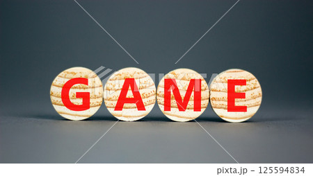 Game symbol. Concept word Game on beautiful wooden circles. Beautiful grey table grey background. Business, lifestyle and game concept. Copy space. 125594834