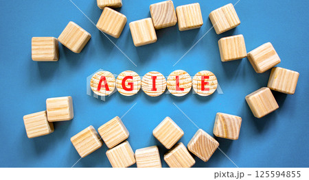 Agile symbol. Concept word Agile on beautiful wooden circles. Beautiful blue table blue background. Beautiful wooden cubes. Business flexible and agile concept. Copy space. Agile symbol. Concept word Agile on beautiful wooden circles. Beautiful blue table blue background. Beautiful wooden cubes. Business flexible and agile concept. Copy space. 125594855