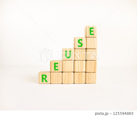 Reuse symbol. Concept word Reuse on beautiful wooden blocks. Beautiful white table white background. Business lifestyle ecological reuse concept. Copy space. Reuse symbol. Concept word Reuse on beautiful wooden blocks. Beautiful white table white background. Business lifestyle ecological reuse concept. Copy space. 125594865