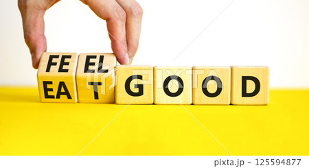 Eat and feel good symbol. Concept words Eat good Feel good on wooden cubes. Beautiful yellow table white background. Doctor hand. Healthy lifestyle eat and feel good concept. Copy space. Eat and feel good symbol. Concept words Eat good Feel good on wooden cubes. Beautiful yellow table white background. Doctor hand. Healthy lifestyle eat and feel good concept. Copy space. 125594877