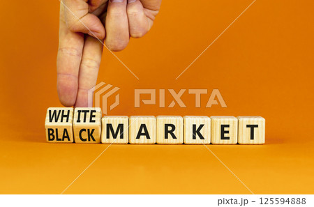 Black or white market symbol. Concept words Black market or White market on beautiful wooden blocks. Beautiful orange background. Businessman hand. Business black or white market concept. Copy space. 125594888