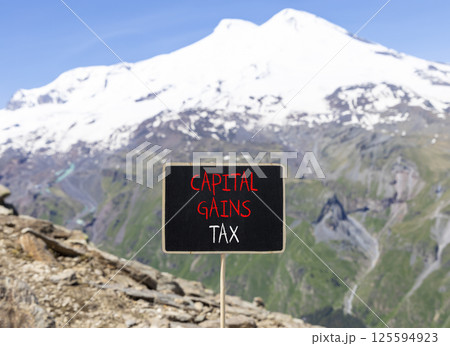 Capital gains tax symbol. Concept words Capital gains tax on beautiful blackboard. Beautiful mountain Elbrus background. Business and capital gains tax concept. Copy space. Capital gains tax symbol. Concept words Capital gains tax on beautiful blackboard. Beautiful mountain Elbrus background. Business and capital gains tax concept. Copy space. 125594923