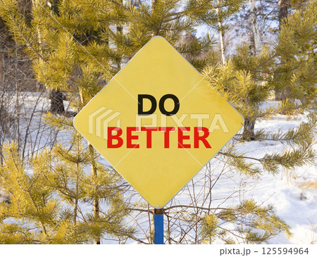 Do better symbol. Concept words Do better on beautiful yellow road sign. Beautiful winter forest background. Business and do better concept. Copy space. Do better symbol. Concept words Do better on beautiful yellow road sign. Beautiful winter forest background. Business and do better concept. Copy space. 125594964