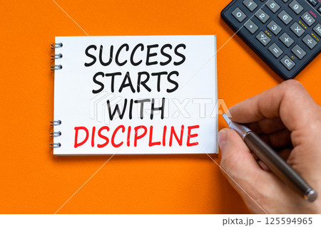 Success starts with discipline symbol. Concept words Success starts with discipline on beautiful white note. Beautiful orange background. Business success starts with discipline concept. Copy space 125594965