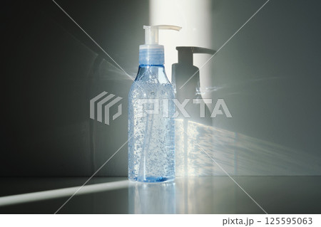 Tube of micellar gel in a ray of sunlight on a shadow background. 125595063