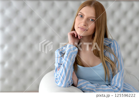 Beauty portrait. Young woman on grey wall background. 125596222