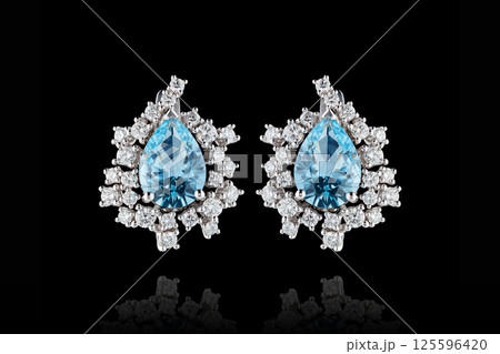 earrings silver, gold with stone aquamarine diamonds on black background 125596420