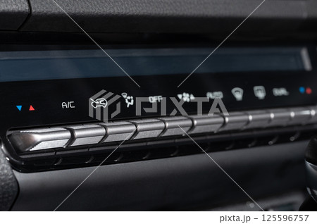 Panel with buttons to control ac in car Panel with buttons to control ac in car 125596757