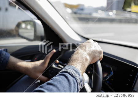 Mens hands on the streering wheel of the car Mens hands on the streering wheel of the car 125596958