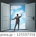 Businessman entering big large door 125597358