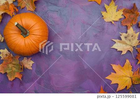 Orange pumpkin on purple background surrounded by autumn maple leaves of red, orange and yellow colors. Changes in the formation of articles about the season, pumpkin recipes, Halloween 125599081