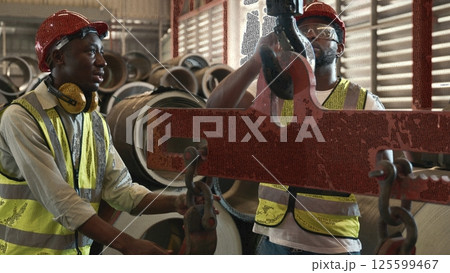 Engineering and worker training or explaining detail weight overhead cranelifting machine, two engineer checking the operation of crane in the factory, recruitment concept Engineering and worker training or explaining detail weight overhead cranelifting machine, two engineer checking the operation of crane in the factory, recruitment concept 125599467