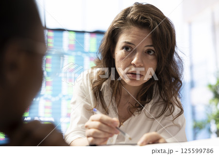 Project leader and her staff conducting a market research for progress plans, learning the trends. Forecast affiliates working on infrastructure investments to fulfill organizational objectives. 125599786