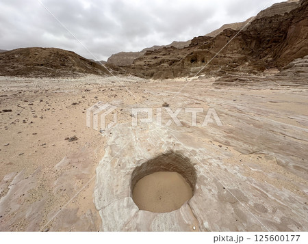 The entrance to an ancient copper mine, covered with sand 125600177