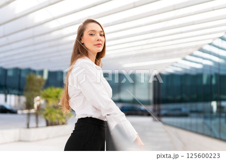 Confident businesswoman in formalwear at workplace Confident businesswoman in formalwear at workplace 125600223