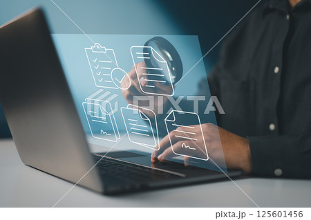 Symbolizes a digital audit process involving thorough inspection of electronic documents and records. 125601456