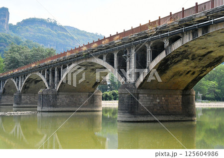 a traditional Chinese style arch bridge on the river 125604986
