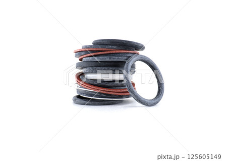 A detailed shot of a stack of assorted o-rings, showcasing mechanical parts and components. A detailed shot of a stack of assorted o-rings, showcasing mechanical parts and components. 125605149