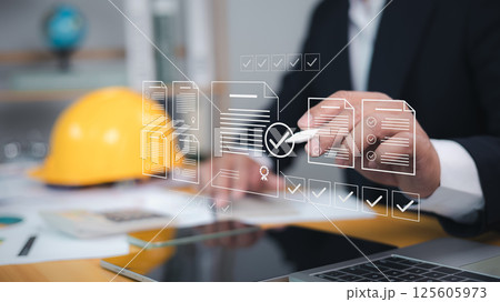 Approved buildings permit concept with approved residential building project, Construction project inspection, Architect or engineer Checking the list of documents and approving the project. Approved buildings permit concept with approved residential building project, Construction project inspection, Architect or engineer Checking the list of documents and approving the project. 125605973