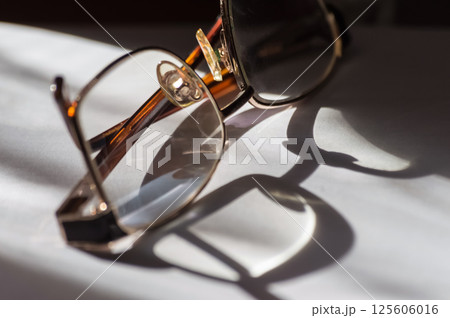Eyeglasses on a white background. tinting. selective focus Eyeglasses on a white background. tinting. selective focus 125606016