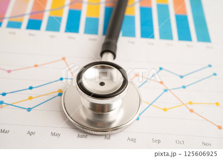 Stethoscope on spreadsheet and graph paper. 125606925