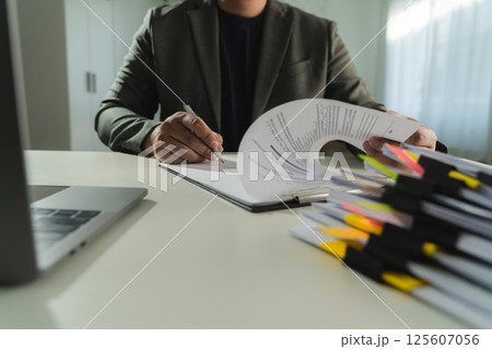 businesswoman signing document On Contract Paper reading and checking financial documents 125607056