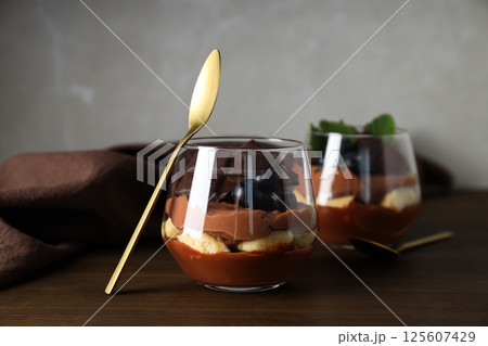 Chocolate mousse in a glass on a dark background. Chocolate mousse in a glass on a dark background. 125607429