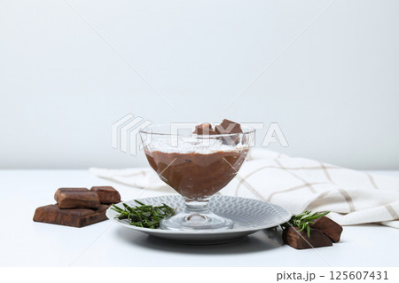 Chocolate mousse and ingredients on a light background. Chocolate mousse and ingredients on a light background. 125607431