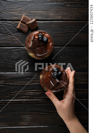 Chocolate mousse in a glass on a dark background. 125607434