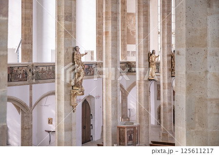 The interior showcases tall columns and intricate details of the late Gothic architecture at the Church of the Assumption of the Virgin Mary in Most, Czechia, reflecting its rich history. The interior showcases tall columns and intricate details of the late Gothic architecture at the Church of the Assumption of the Virgin Mary in Most, Czechia, reflecting its rich history. 125611217