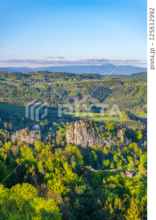 Explore the stunning landscape from Pantheon Lookout in Bohemian Paradise, featuring lush greenery and the majestic Krkonose Mountains in the background, showcasing nature's beauty in Czechia. Explore the stunning landscape from Pantheon Lookout in Bohemian Paradise, featuring lush greenery and the majestic Krkonose Mountains in the background, showcasing nature's beauty in Czechia. 125612992