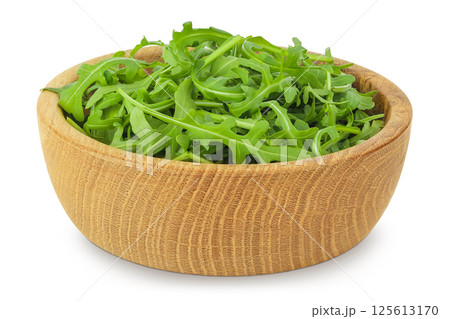 Heap of green fresh rucola or arugula leaf in wooden bowl isolated on white background Heap of green fresh rucola or arugula leaf in wooden bowl isolated on white background 125613170
