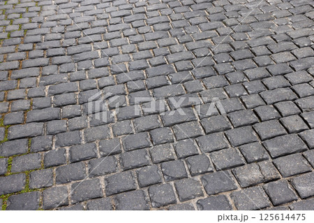 Textured cobblestone street surface showing distinct patterning 125614475