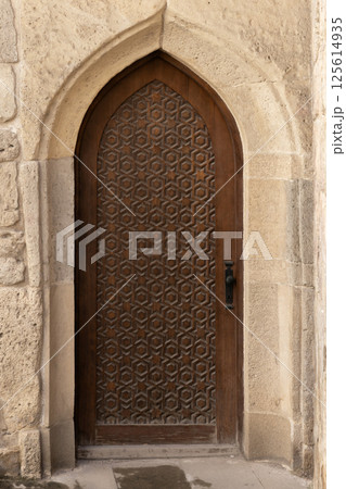 Vertical photo of a beautiful handcrafted wooden door set Vertical photo of a beautiful handcrafted wooden door set 125614935
