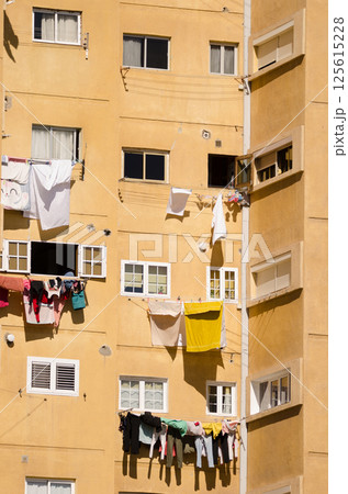 Residential building with clothes hanging. 125615228