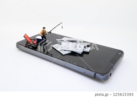 Concept of Money Fishing on Smartphone with Miniature Figures Concept of Money Fishing on Smartphone with Miniature Figures 125615393